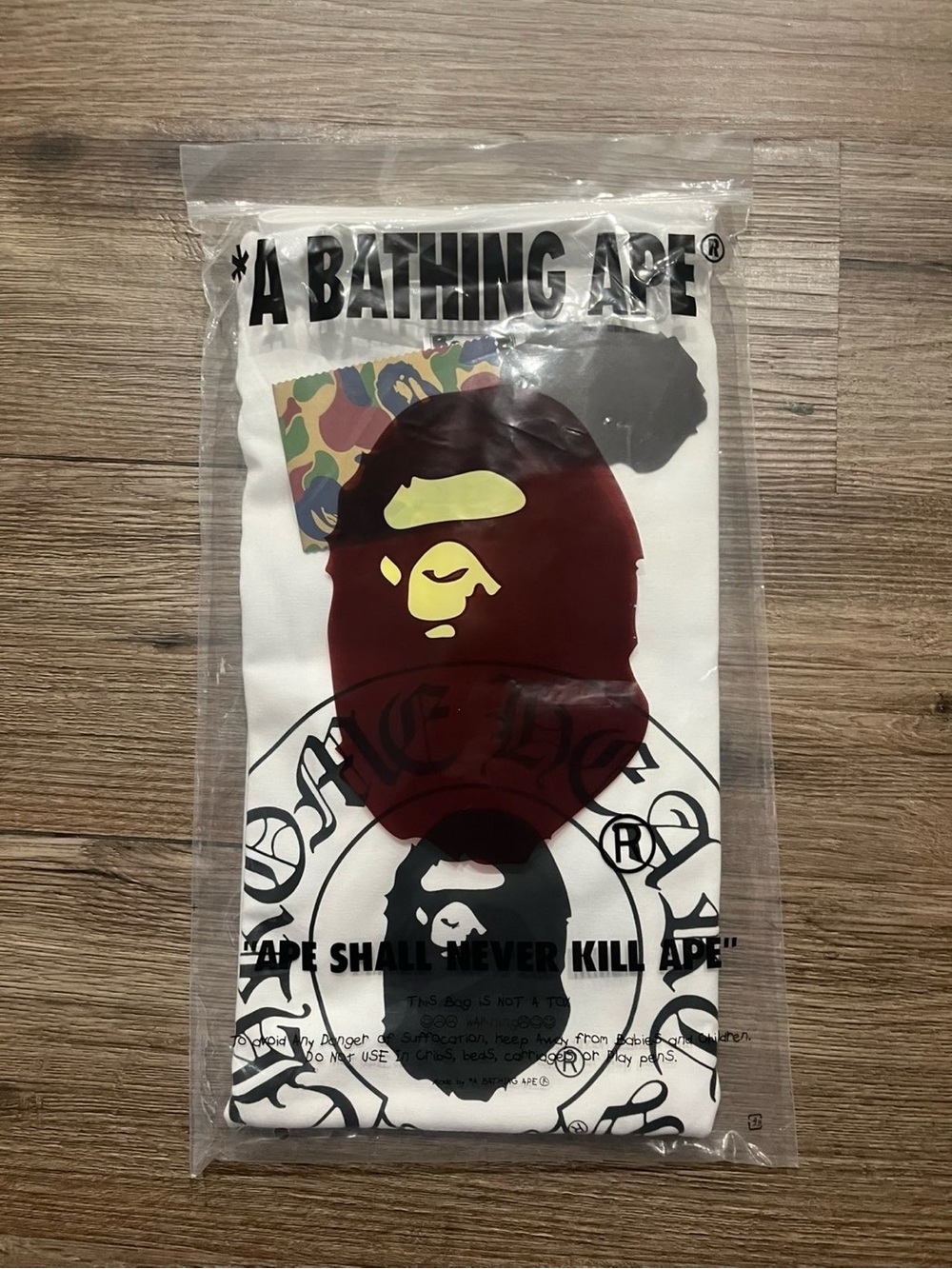 Bape Kids White Tee with Maroon Ape Head and Yellow Accent